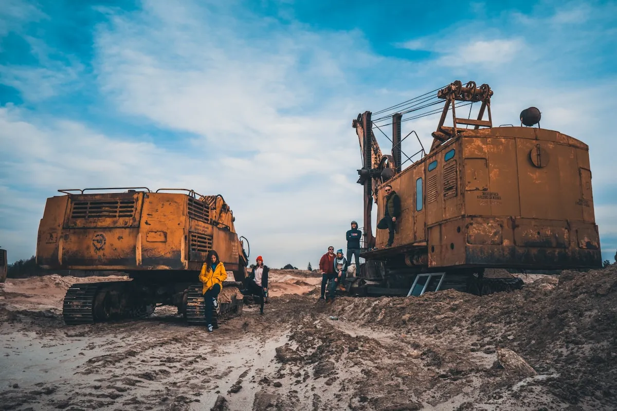 Heavy yellow mining equipment operating at an open-pit gold mine, representing the industrial scale of gold extraction