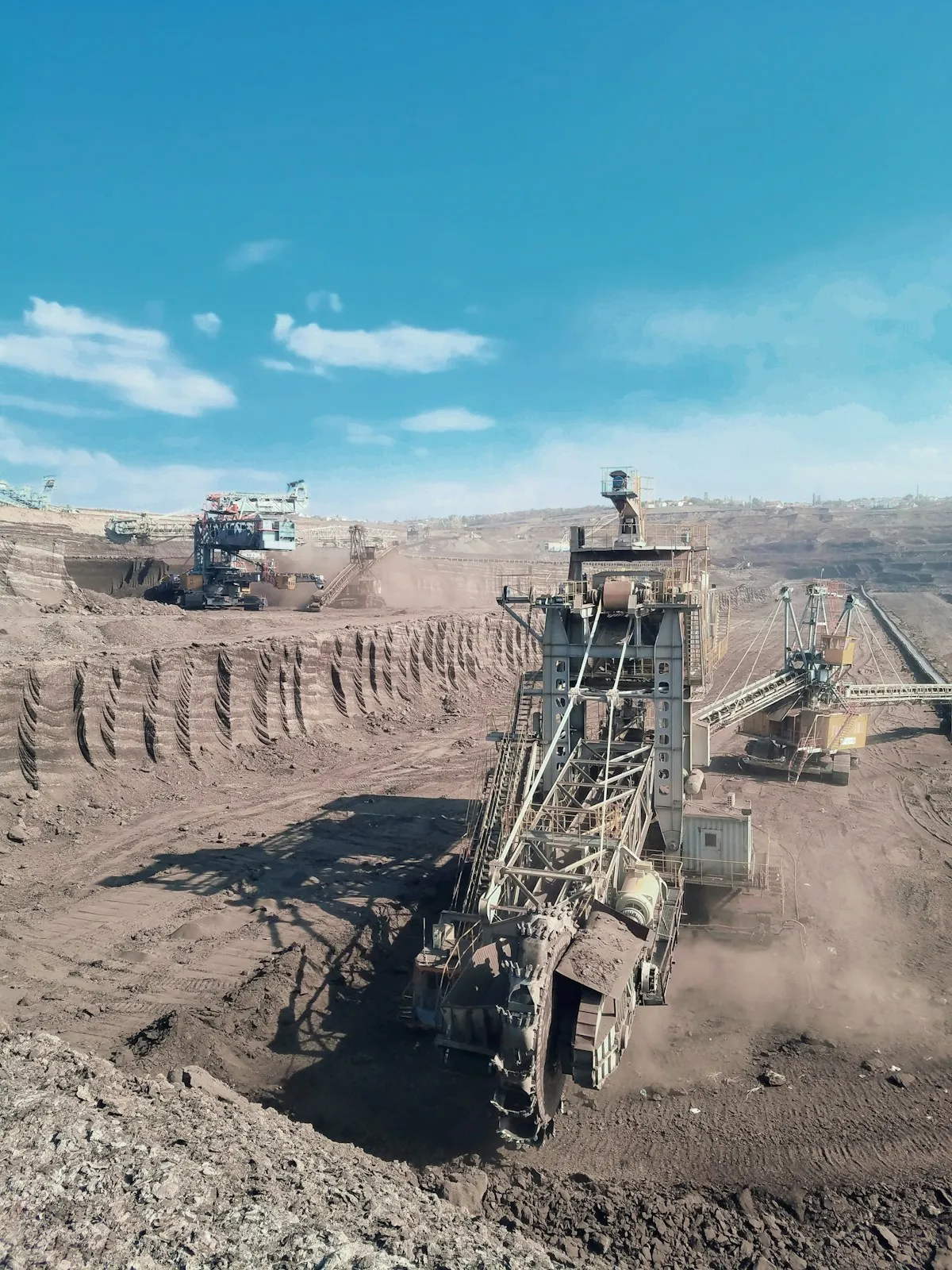 Heavy machinery operating in an open-pit mine, representing the massive scale of modern gold extraction operations
