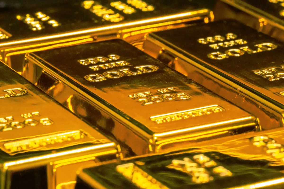 Gold bars stacked in a secure vault, representing wealth preservation
