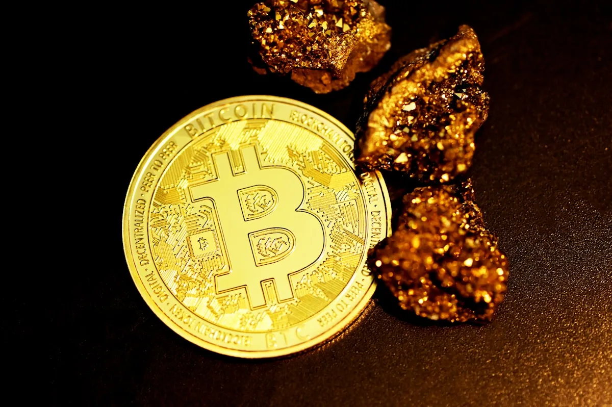 Gold coins and nuggets arranged together, illustrating the range of gold purity from raw material to refined investment products