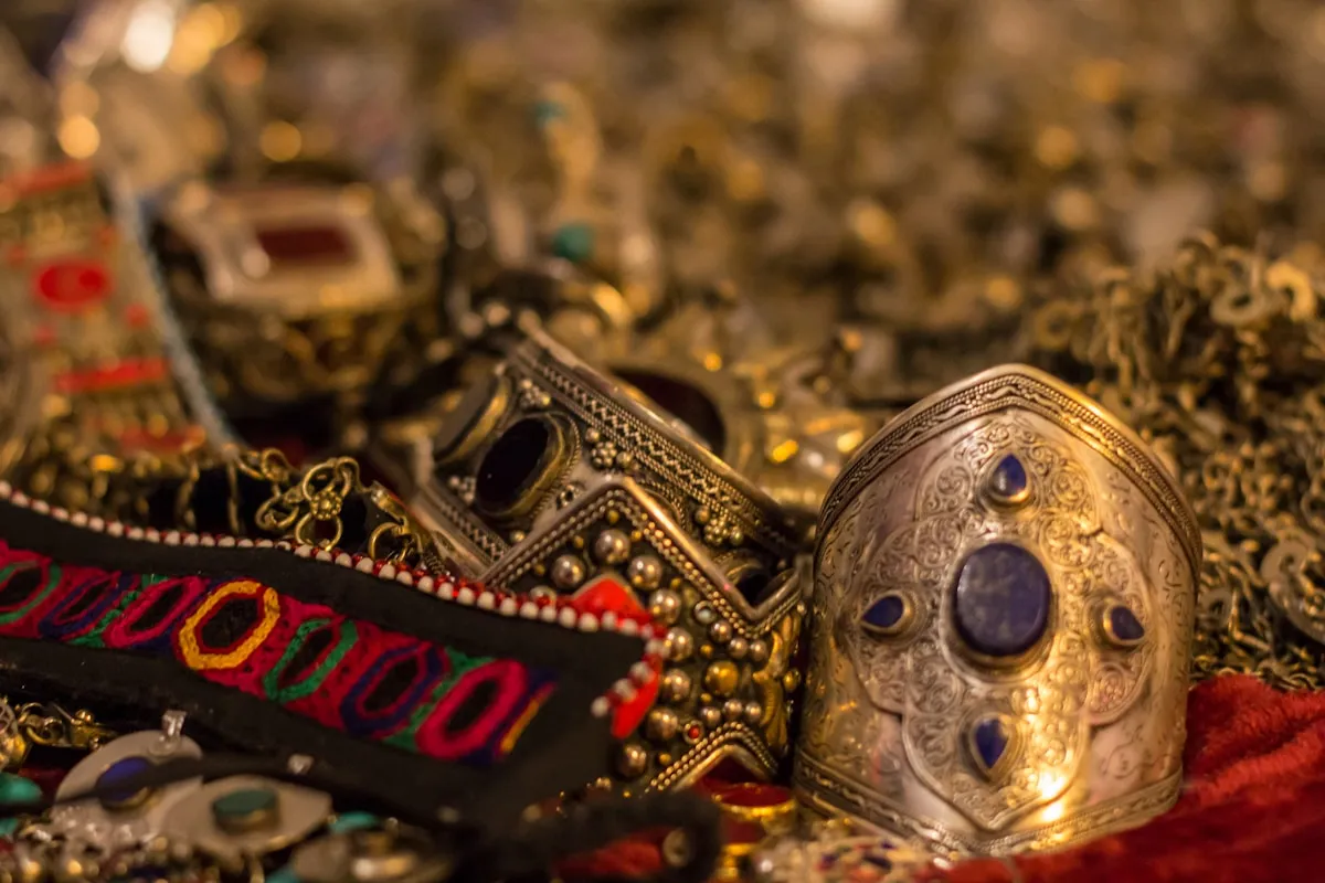 Ancient ceremonial masks displayed on a table, evoking the golden death masks that have defined our understanding of lost civilizations