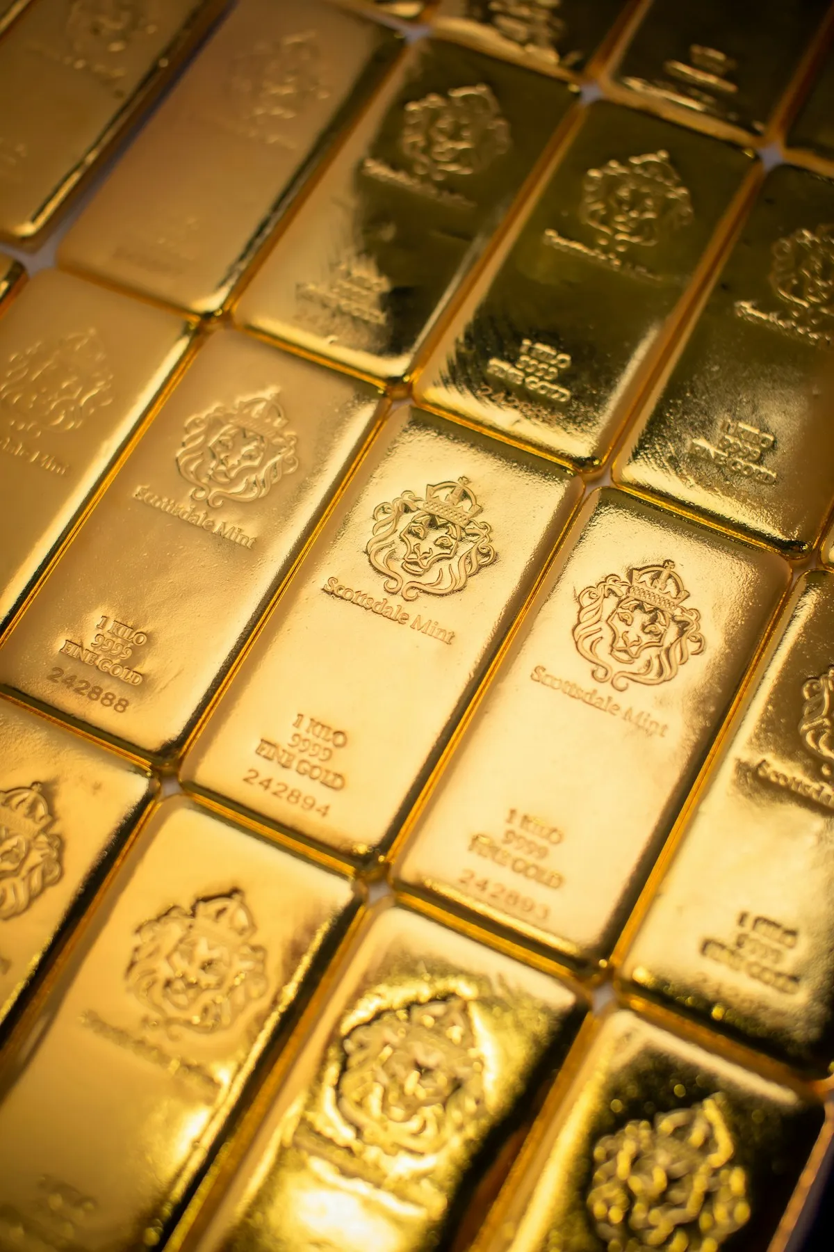A pile of gold bars stacked on a table — the starting point for every gold investor’s journey