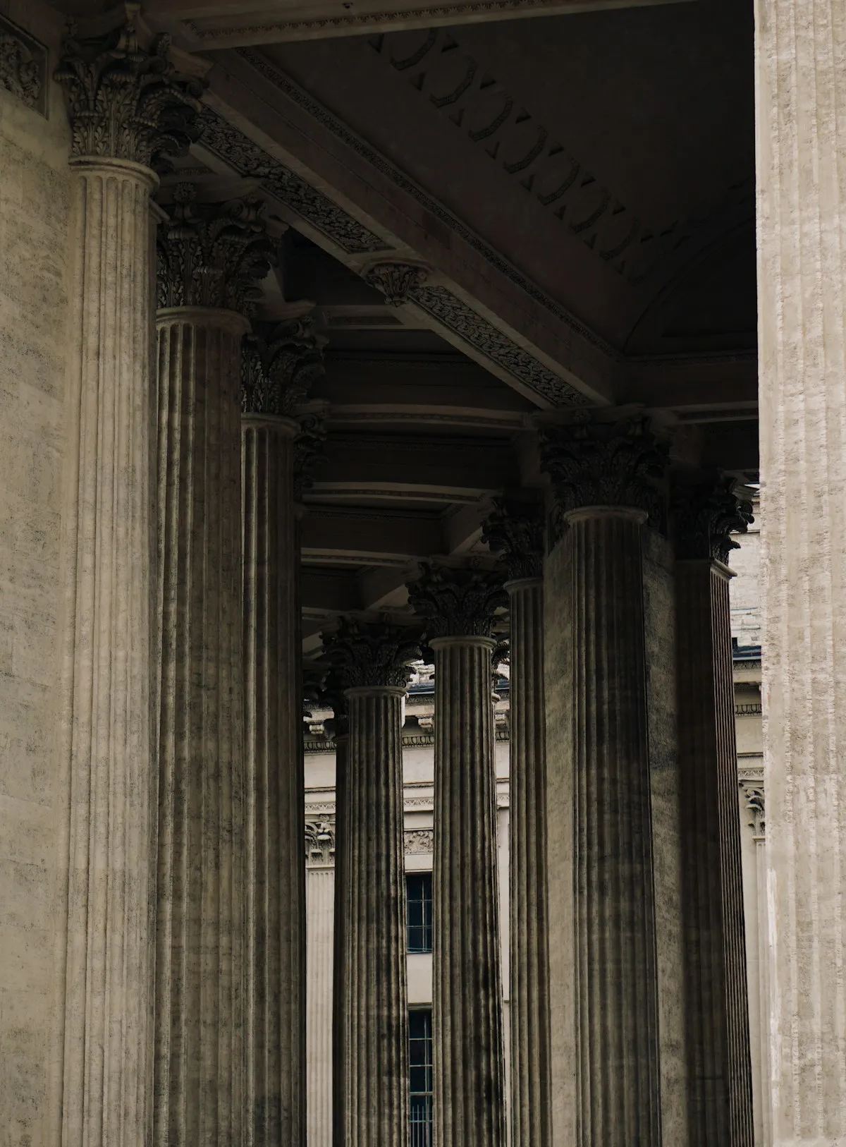 Man sitting on a bench outside a financial building, contemplating retirement planning decisions