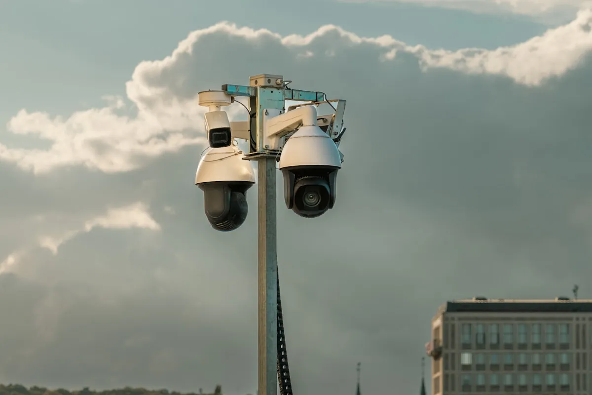 Security cameras mounted on a pole with dramatic clouds, preparation and vigilance are your best defense when storms and disasters threaten