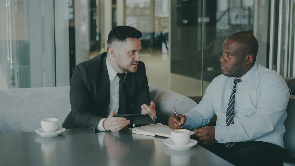 Business professionals reviewing documents together over coffee, illustrating the due diligence process when vetting gold dealers