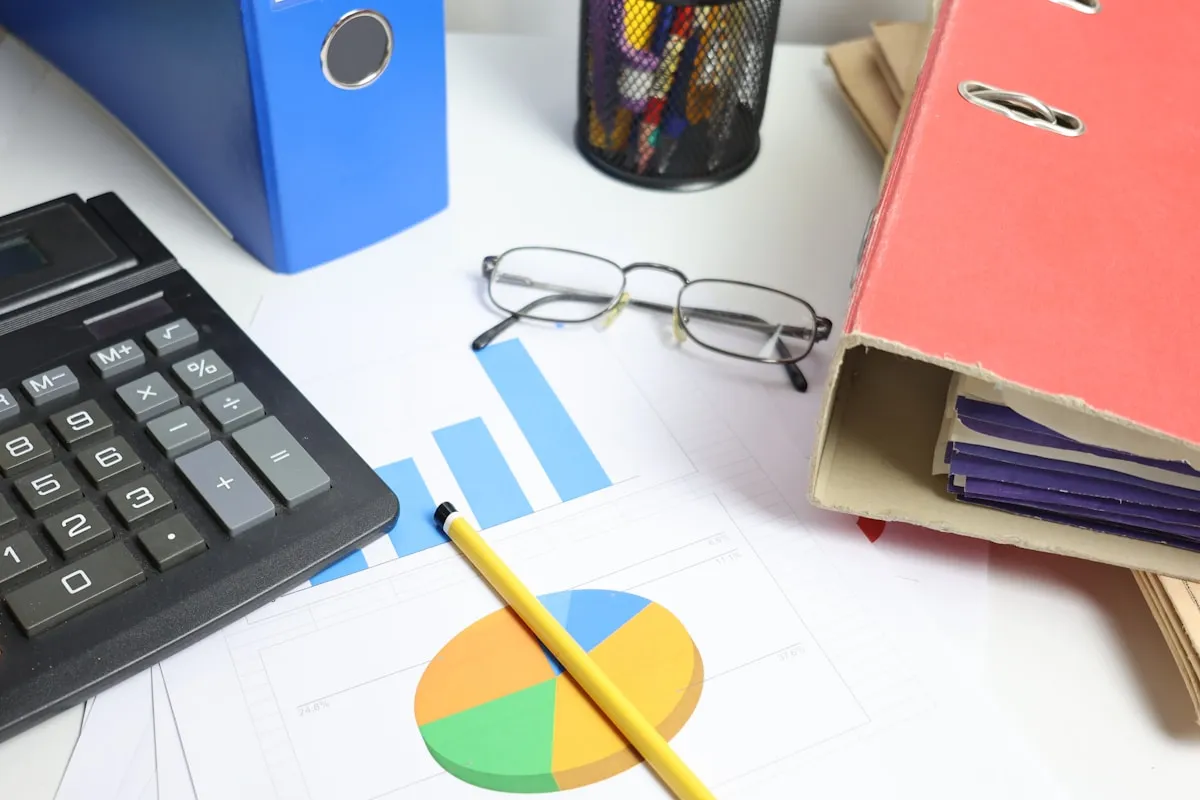 A desk with calculator, charts, and binders — the tools of disciplined portfolio allocation